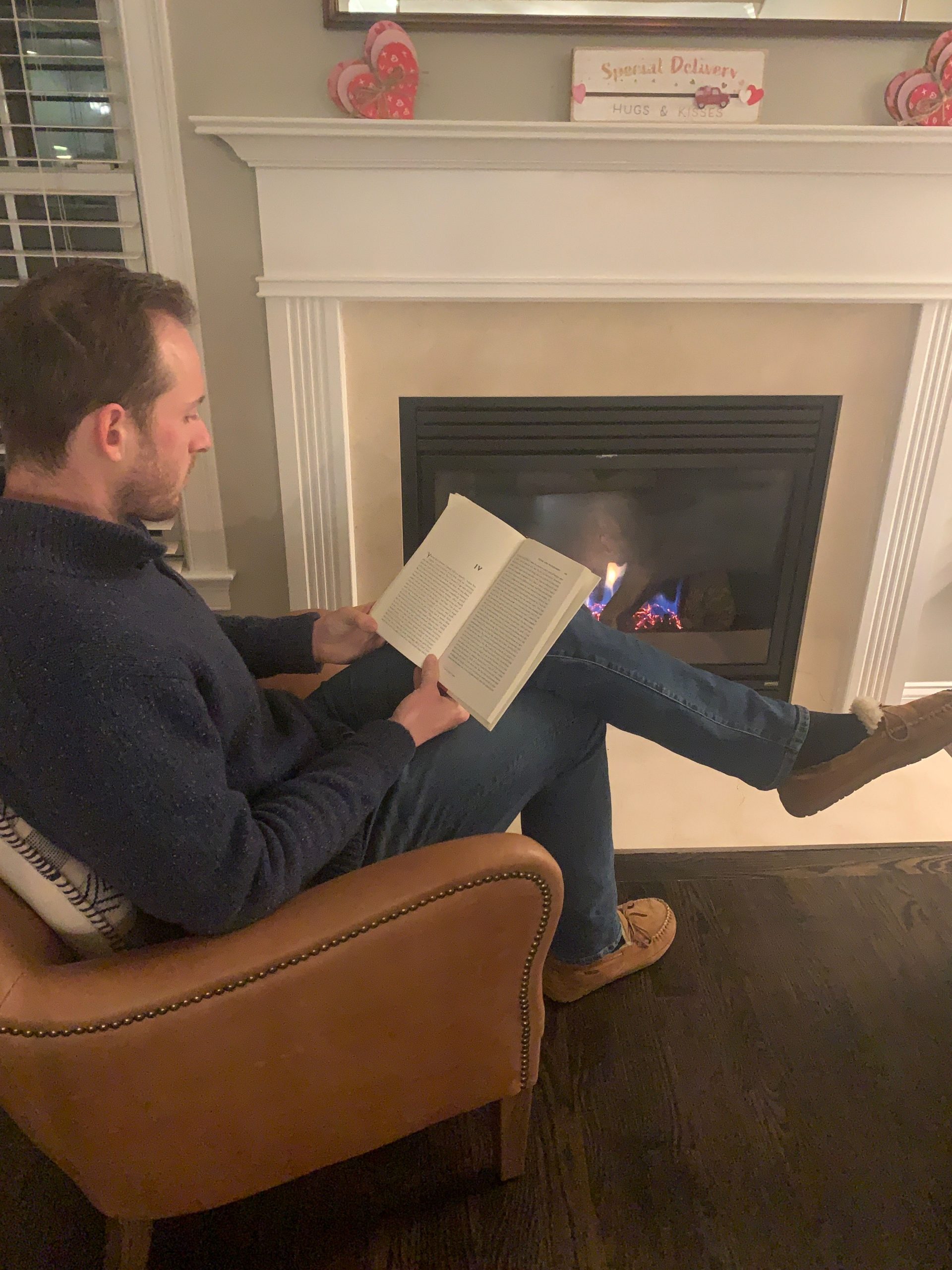 reading by fireplace